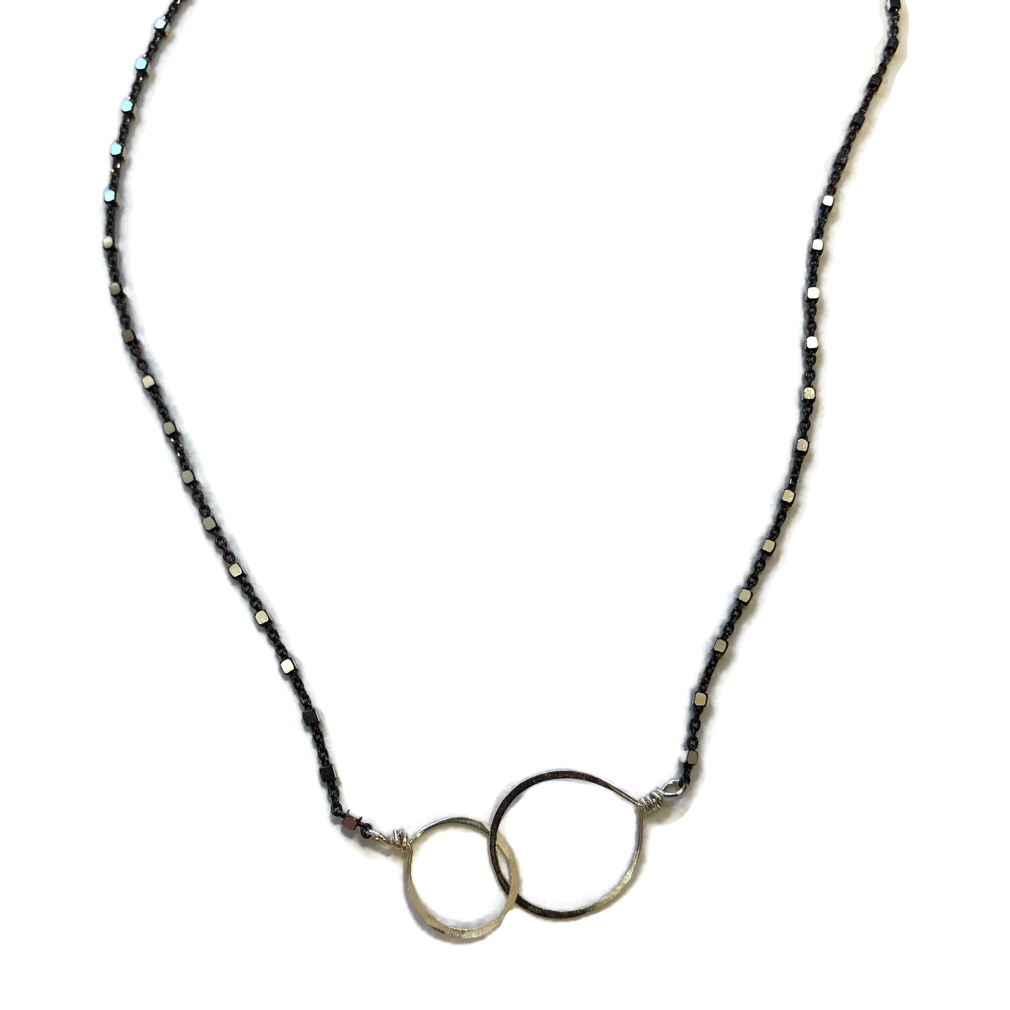 necklace with thin black chain with tiny silver beads featuring 2 hammered interlocking circles, beth jewelry