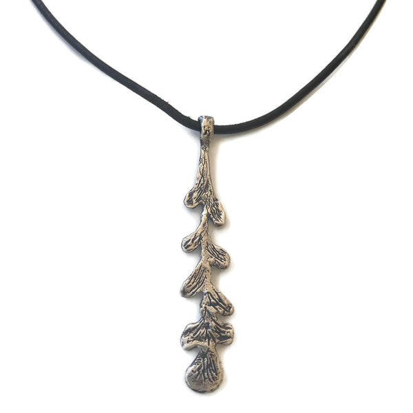 hand-carved silver leaf pendant on dark brown leather