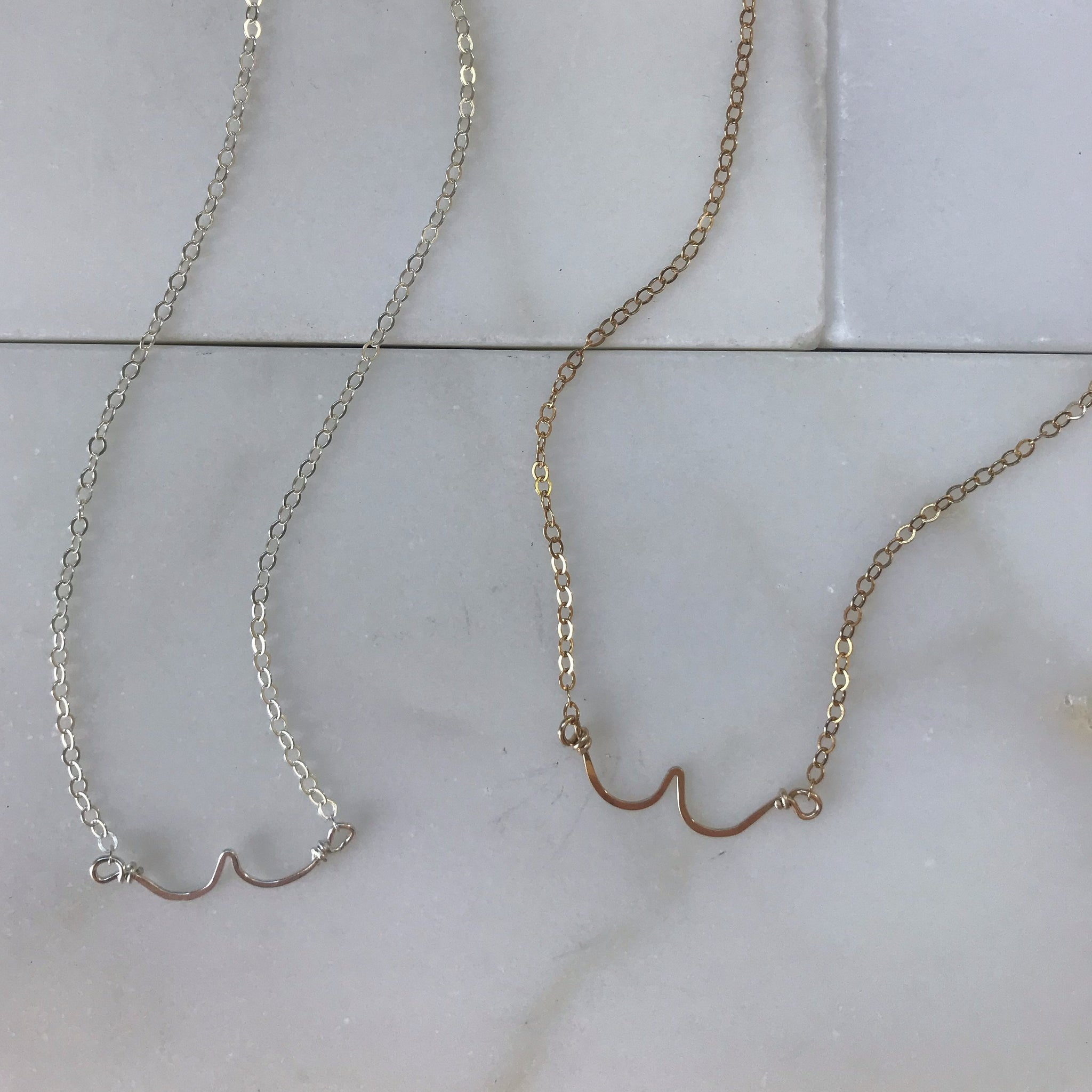 hand formed boobies necklaces in silver and gold
